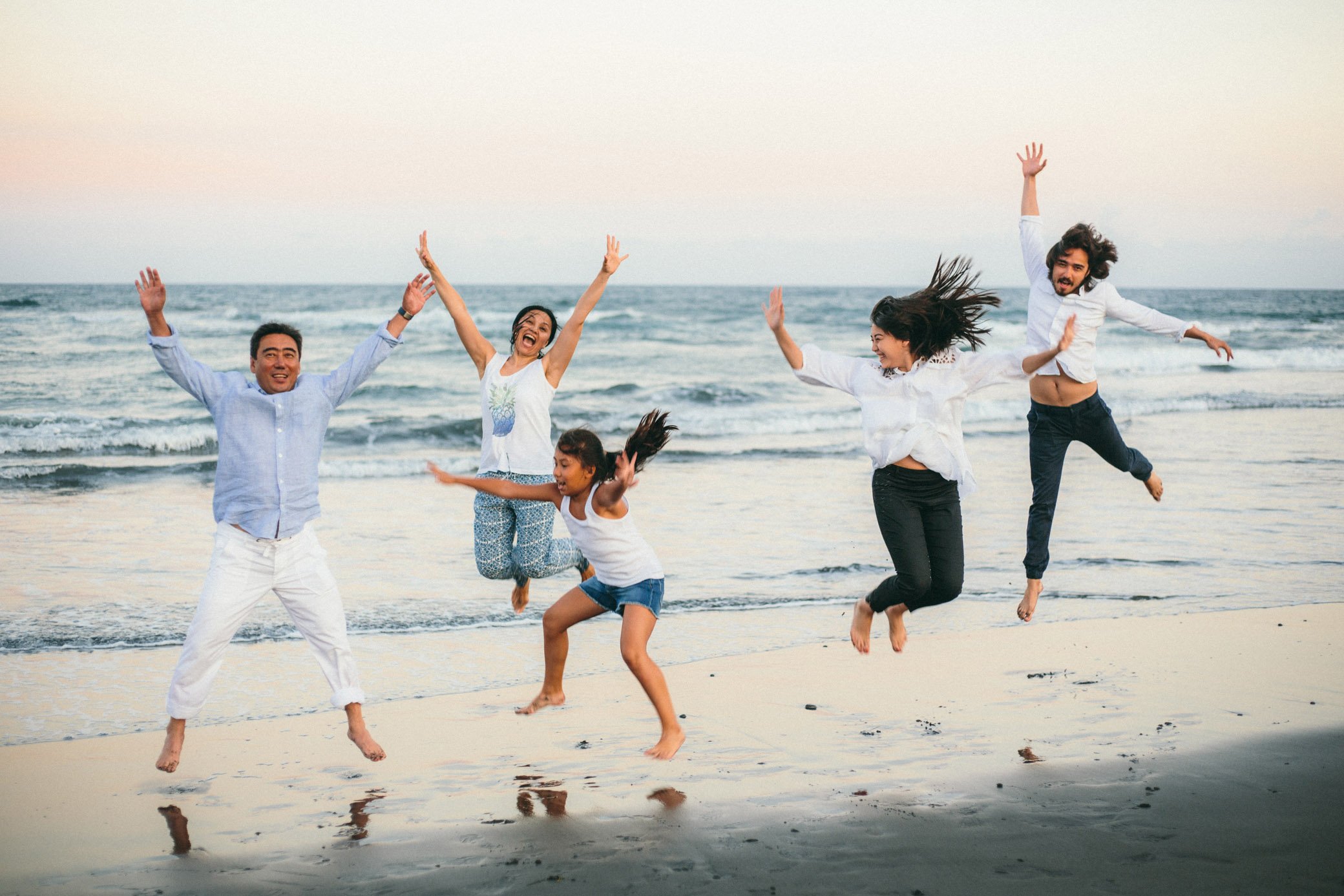  Family photo session on the beach with black sand Tanah Lot. Three children. The big family