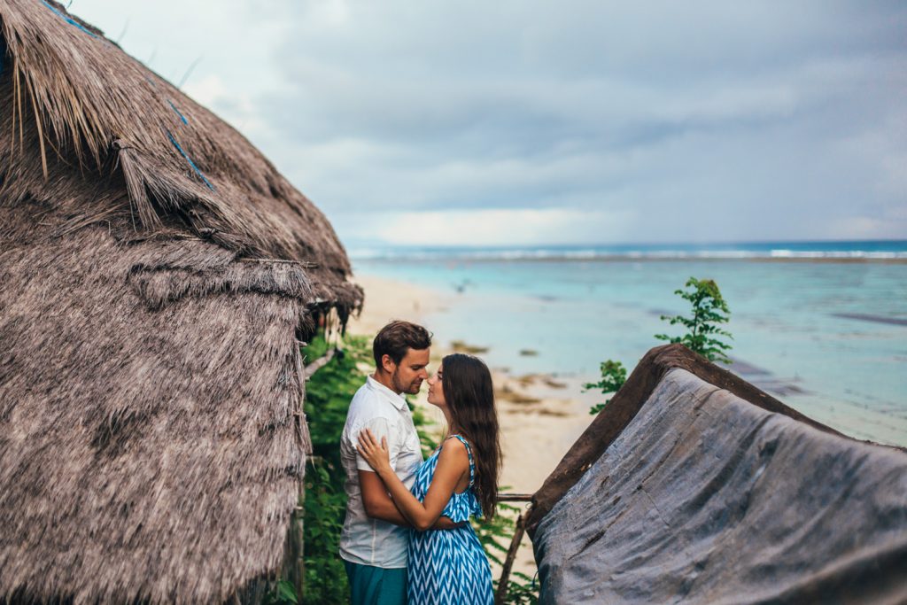 
A girl in a blue dress hugs her boyfriend in a white shirt and blue pants. Clothing for photo sessions